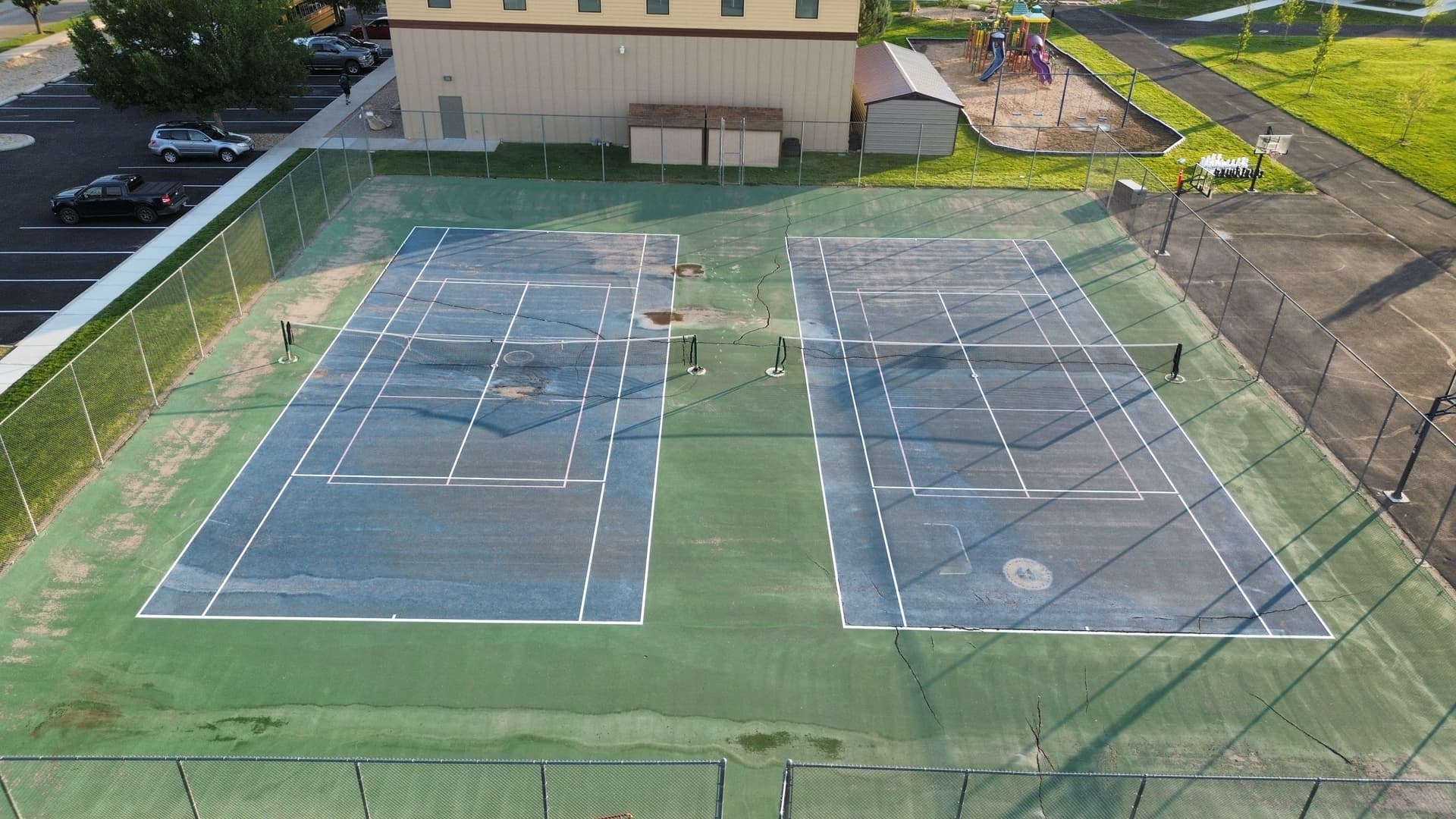 tennis court surface cracks and wear